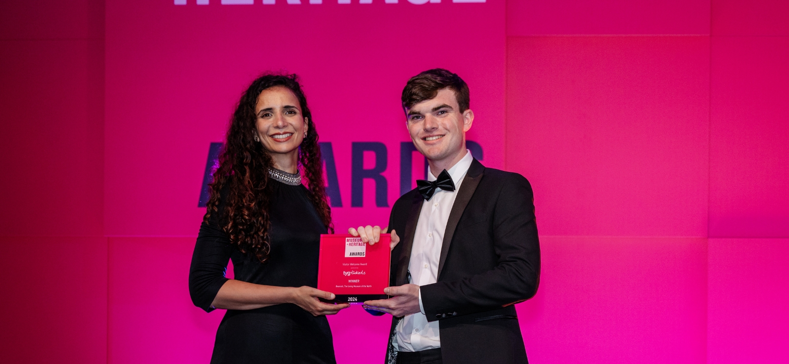 Two people getting an award