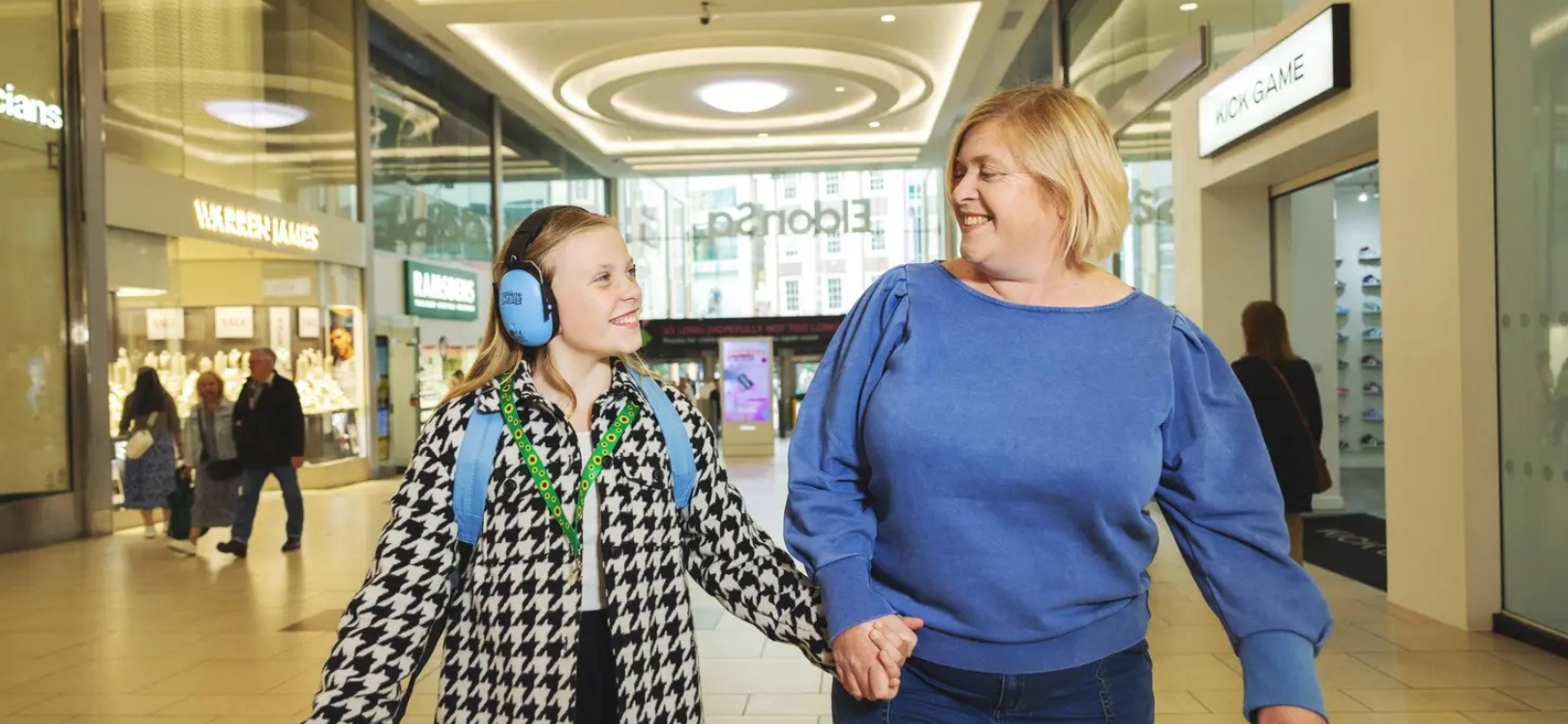 A woman and young girl walking through Eldon Square shopping centre