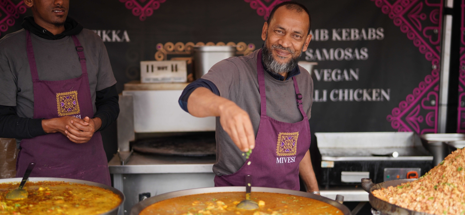 Two people working on a food stall