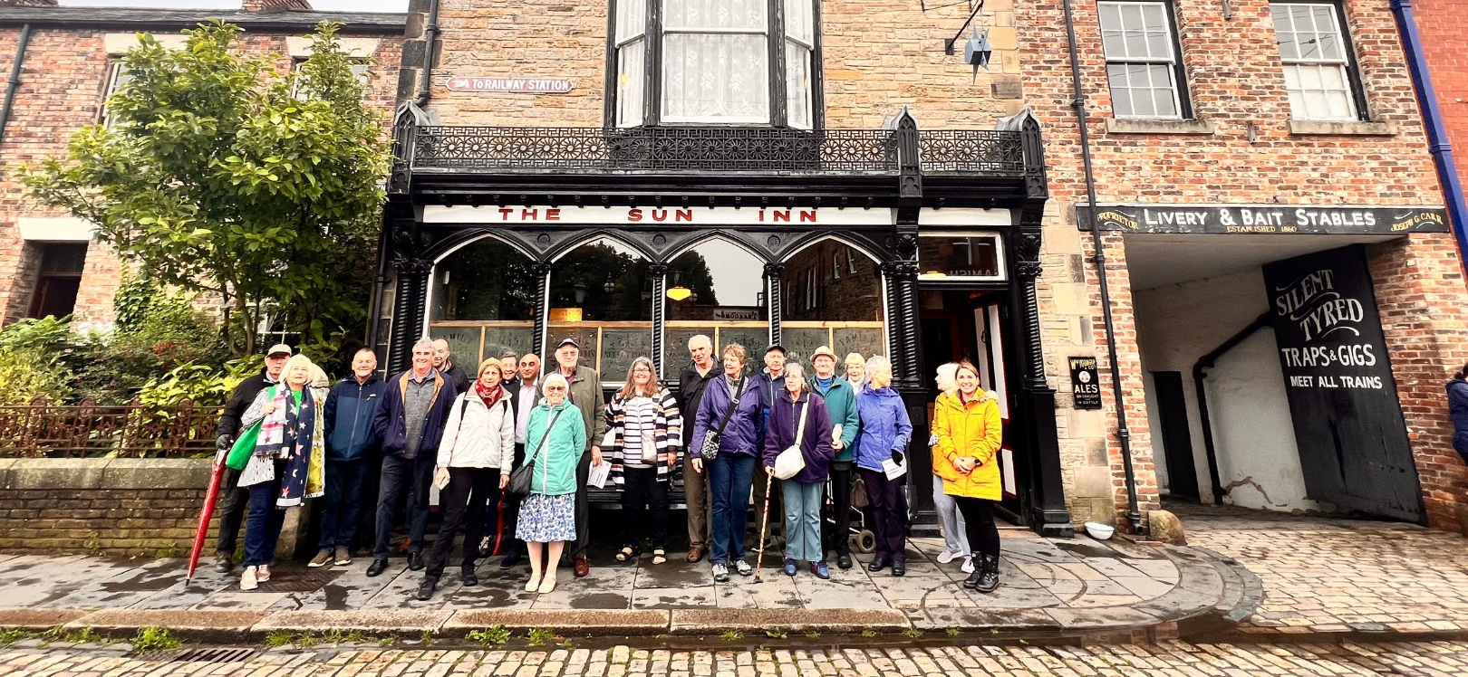 A group of people outside The Sun Inn at Beamish Museum