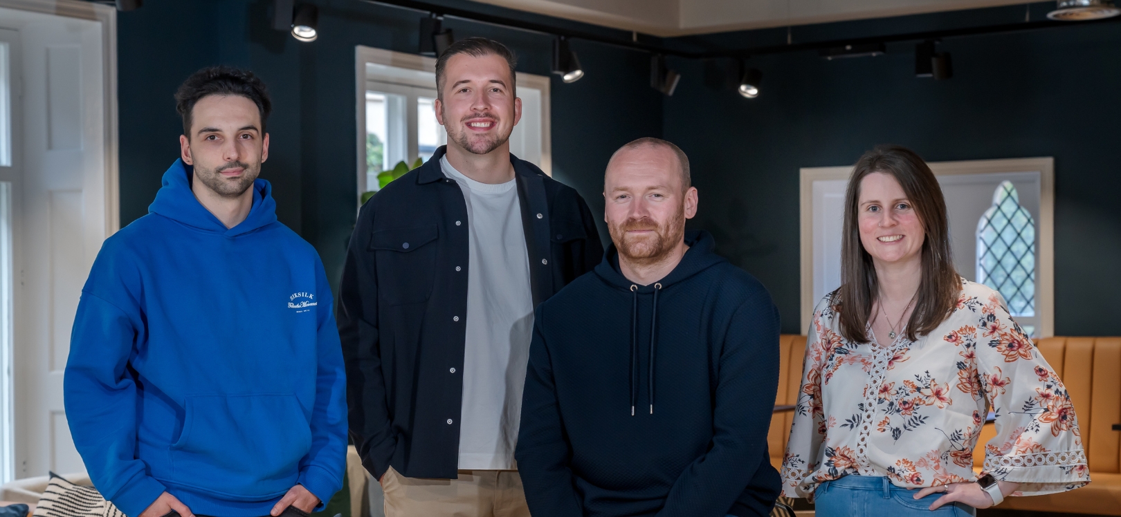 Four people stood in a room