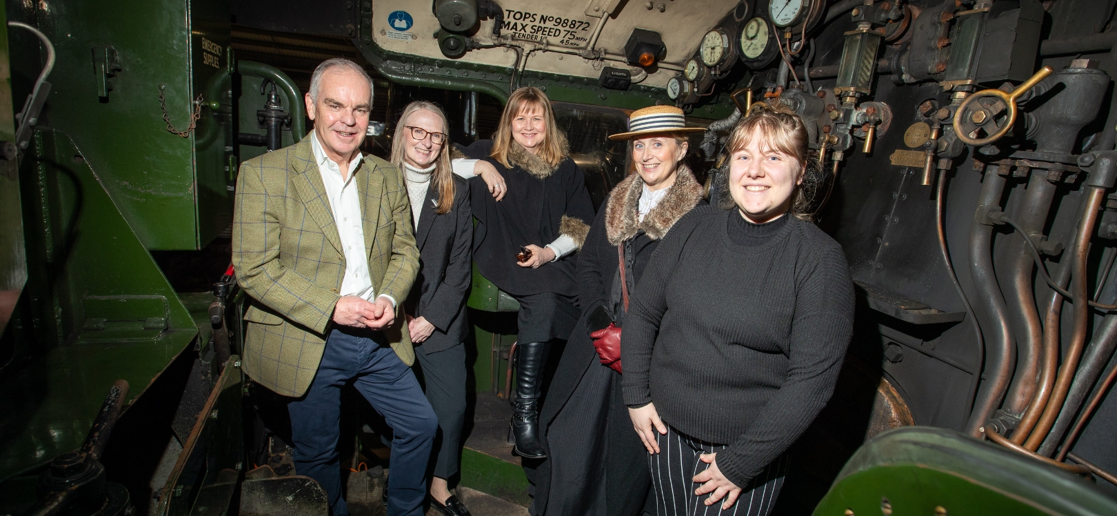 A group of people next to a train