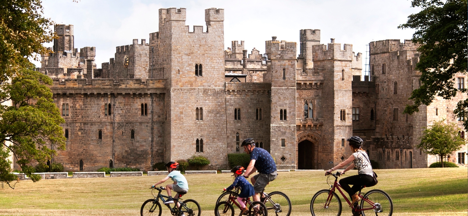 A family cycling at Raby Castle